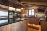 This stunning kitchen boasts a rustic charm with its wooden cabinetry and island, creating a warm and inviting atmosphere.