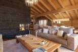Experience luxury living in this stunning chalet, featuring a cozy fireplace and a beautifully designed wooden ceiling.
