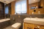 This cozy bathroom features a modern design with a touch of rustic charm.