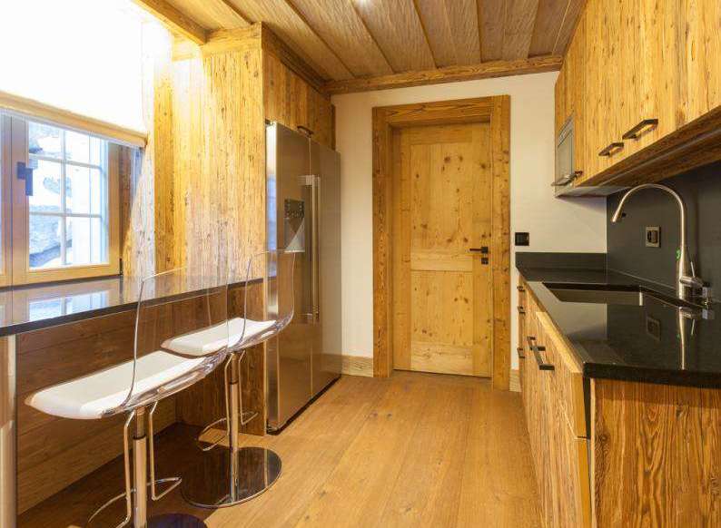 This stunning kitchen boasts a rustic charm with its wooden cabinetry and flooring, creating a warm and inviting atmosphere.