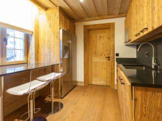 This stunning kitchen boasts a rustic charm with its wooden cabinetry and flooring, creating a warm and inviting atmosphere.