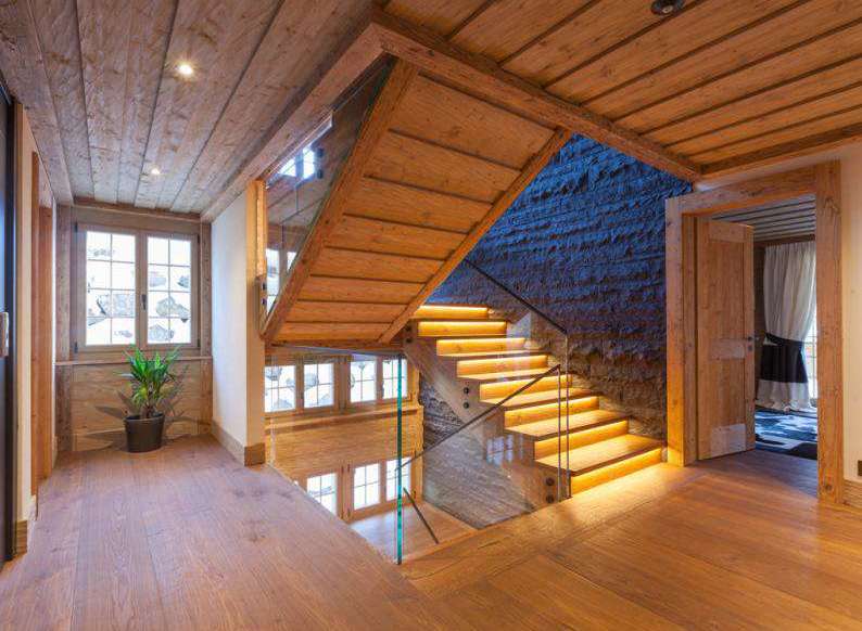 Step into luxury with this stunning property featuring a beautifully crafted wooden staircase.