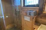 Experience rustic charm in this cozy bathroom.