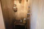 Step into a rustic oasis with this unique wooden shower.