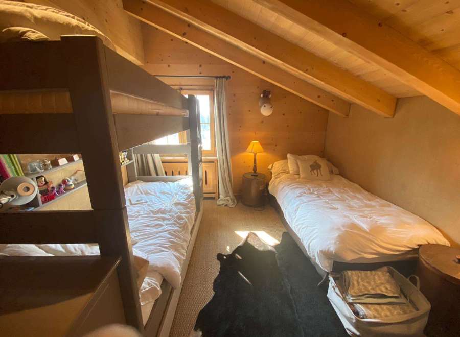 Cozy bedroom with bunk beds and a single bed, perfect for a family getaway.