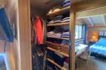 Step into a cozy bedroom with a charming closet.