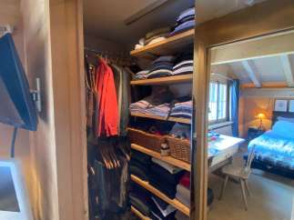 Step into a cozy bedroom with a charming closet.