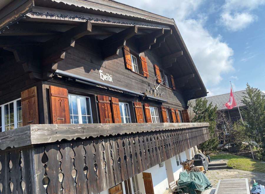 Discover the charm of this traditional Swiss chalet, featuring a beautifully crafted wooden facade and intricate balcony details.
