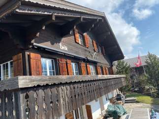 Discover the charm of this traditional Swiss chalet, featuring a beautifully crafted wooden facade and intricate balcony details.