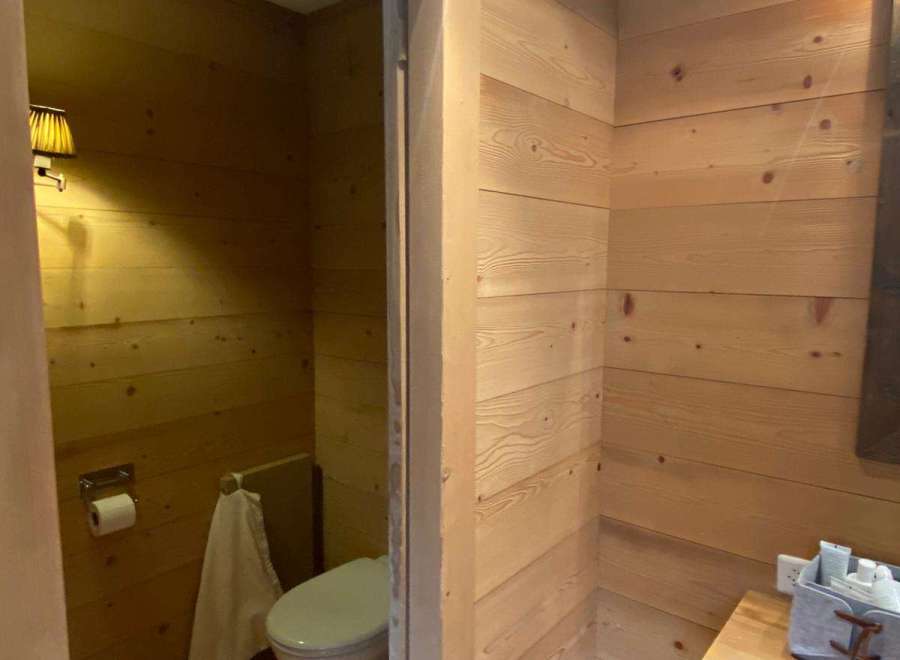 Step into a cozy bathroom retreat with warm wooden accents.