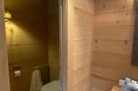 Step into a cozy bathroom retreat with warm wooden accents.