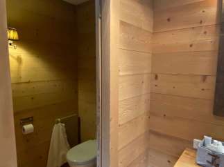 Step into a cozy bathroom retreat with warm wooden accents.
