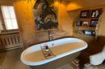 Indulge in luxury within this stunning bathroom, featuring a unique freestanding bathtub.