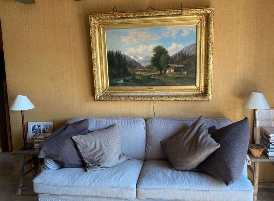 This cozy living space features a comfortable sofa adorned with plush pillows, creating an inviting atmosphere.