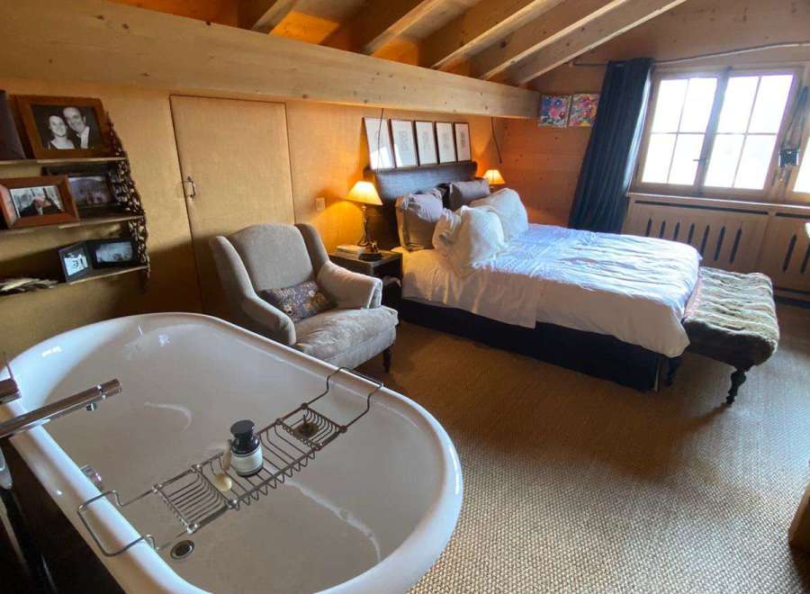 Indulge in luxury in this stunning bedroom featuring a freestanding bathtub, perfect for a relaxing soak.