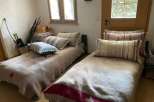 Cozy bedroom with two single beds, perfect for a guest room or a small space.