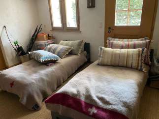 Cozy bedroom with two single beds, perfect for a guest room or a small space.