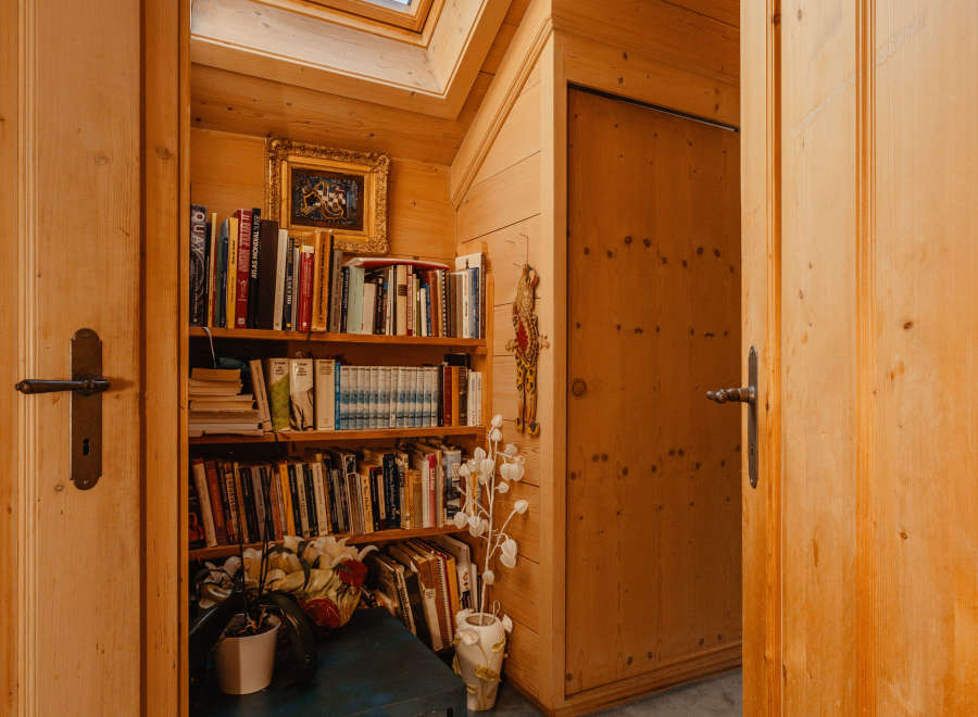 Step into a cozy reading nook bathed in natural light from a skylight.