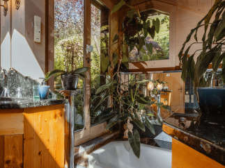 Experience the tranquility of this stunning bathroom, featuring a luxurious bathtub and a serene view of the outdoors.