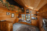 Step into a cozy cabin retreat with warm wooden interiors and a charming ambiance.