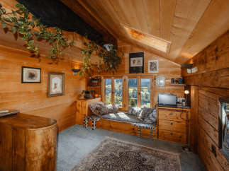 Step into a cozy cabin retreat with warm wooden interiors and a charming ambiance.