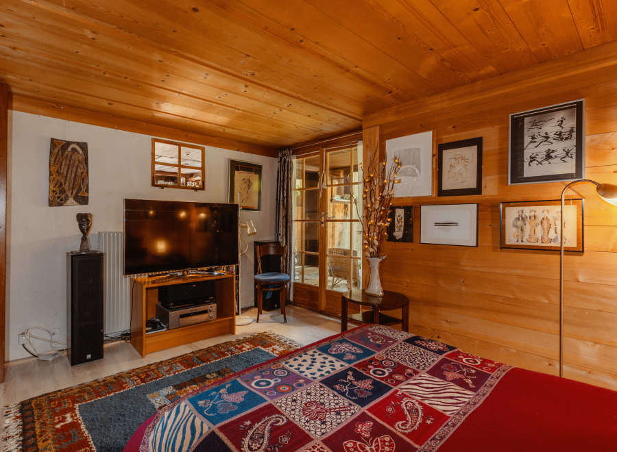 Cozy bedroom with wood paneling and a warm ambiance.