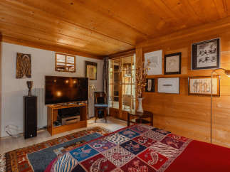 Cozy bedroom with wood paneling and a warm ambiance.