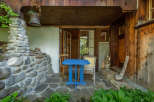 Discover the charm of this rustic retreat, featuring a cozy outdoor seating area perfect for relaxation.