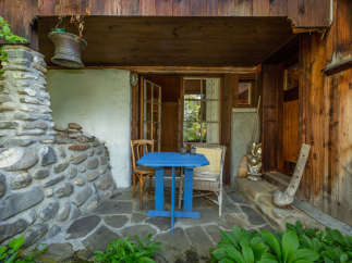 Discover the charm of this rustic retreat, featuring a cozy outdoor seating area perfect for relaxation.