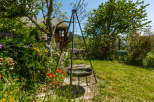 Discover the charm of this idyllic property, featuring a lush garden bursting with colorful flowers.