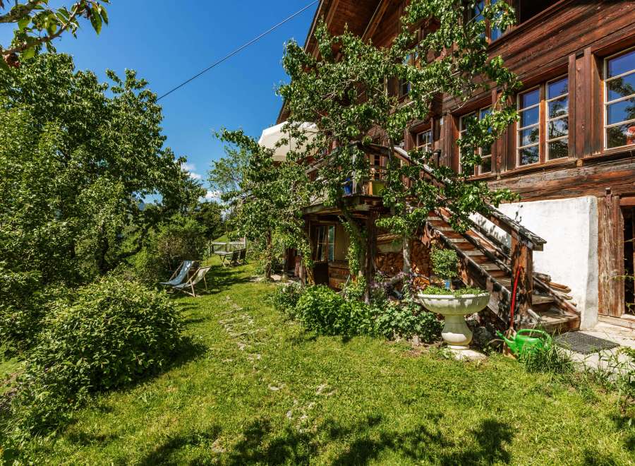 Discover the charm of this beautiful wooden house nestled in a lush green garden.