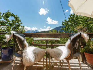 Enjoy breathtaking mountain views from this charming outdoor seating area.