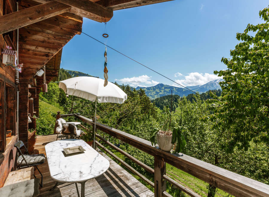Enjoy breathtaking mountain views from this charming chalet's balcony.