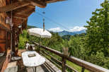 Enjoy breathtaking mountain views from this charming chalet's balcony.
