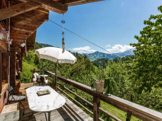 Enjoy breathtaking mountain views from this charming chalet's balcony.