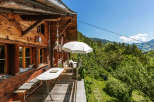 Escape to a charming wooden cabin nestled in the mountains, offering a serene retreat.