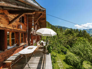 Escape to a charming wooden cabin nestled in the mountains, offering a serene retreat.
