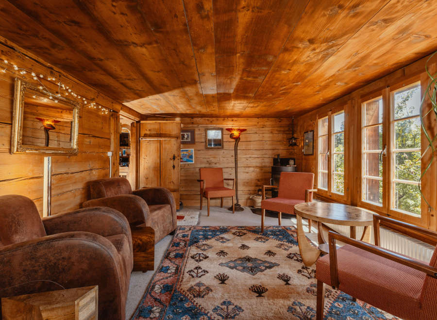Step into a cozy cabin retreat with warm wooden interiors and inviting seating areas.