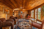 Step into a cozy cabin retreat with warm wooden interiors and inviting seating areas.