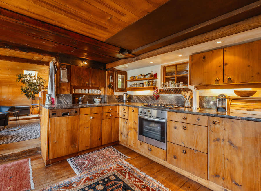 This rustic kitchen boasts beautiful wooden cabinetry and a warm, inviting atmosphere.