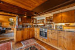 This rustic kitchen boasts beautiful wooden cabinetry and a warm, inviting atmosphere.