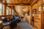 Step into a cozy cabin retreat with warm wooden interiors.