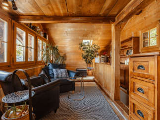 Step into a cozy cabin retreat with warm wooden interiors.
