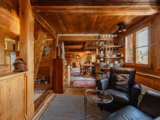 Step into a cozy, rustic retreat with this charming wooden interior.