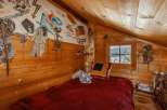 Cozy cabin bedroom with wooden walls and a charming, rustic aesthetic.