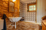 Step into a charming bathroom with a rustic wooden aesthetic.