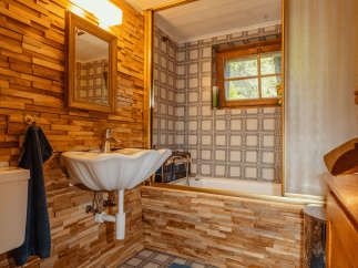 Step into a charming bathroom with a rustic wooden aesthetic.