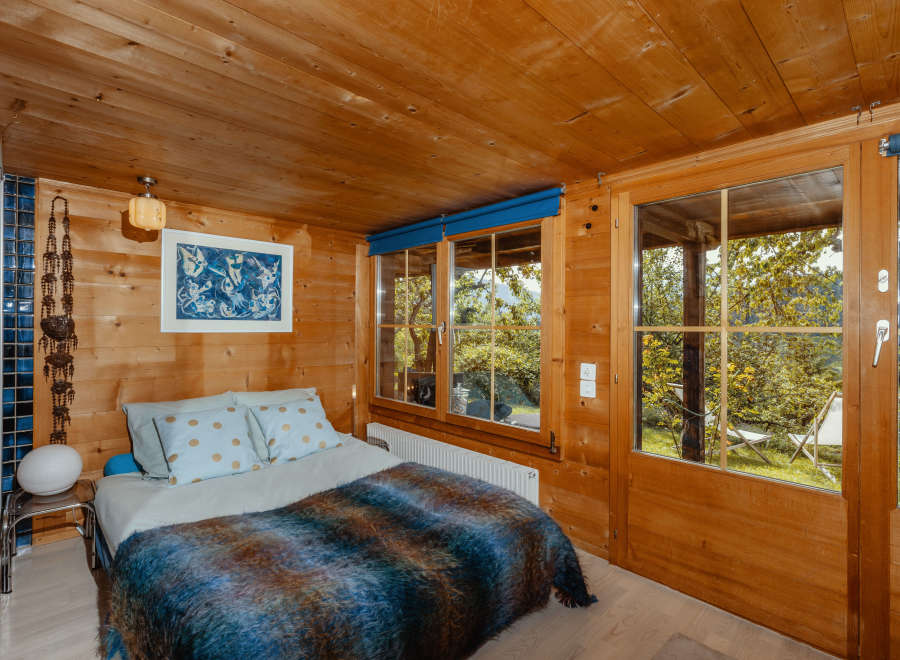 Step into a cozy bedroom retreat with warm wooden accents and a serene ambiance.