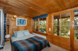 Step into a cozy bedroom retreat with warm wooden accents and a serene ambiance.