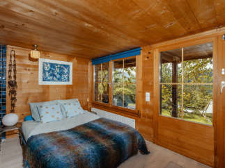 Step into a cozy bedroom retreat with warm wooden accents and a serene ambiance.